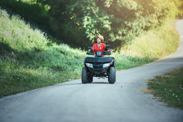 A trip on the ATV on the red road.A trip on the ATV on the road.