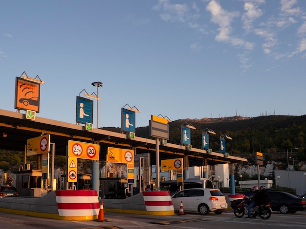 Trip on the toll highway AthensThessaloniki past cars gas stations toll checkpoints at sunset