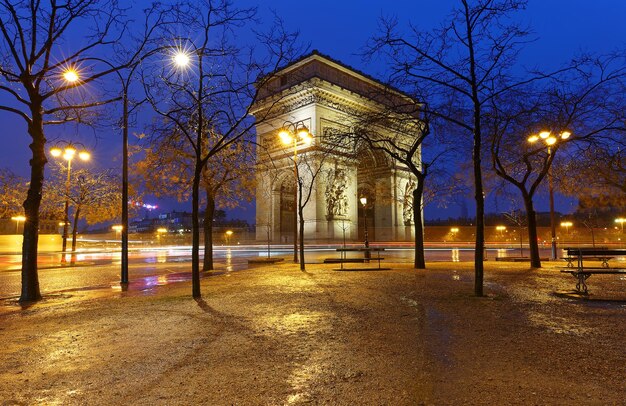 The Triumphal Arch in rainy evening Paris France