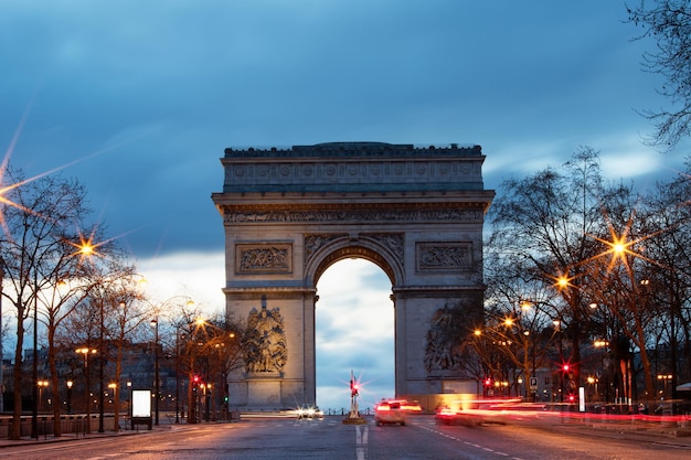 The Triumphal Arch in rainy evening Paris France