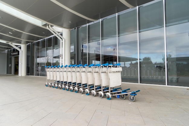 Trolleys luggage in a raw in modern airport