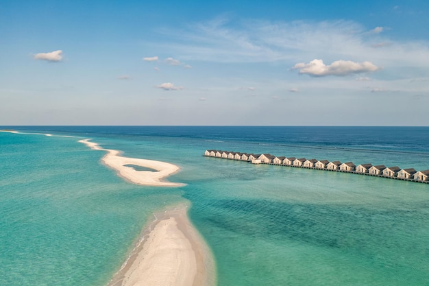 Tropical aerial landscape, seascape water bungalows villas with amazing sea lagoon beach.