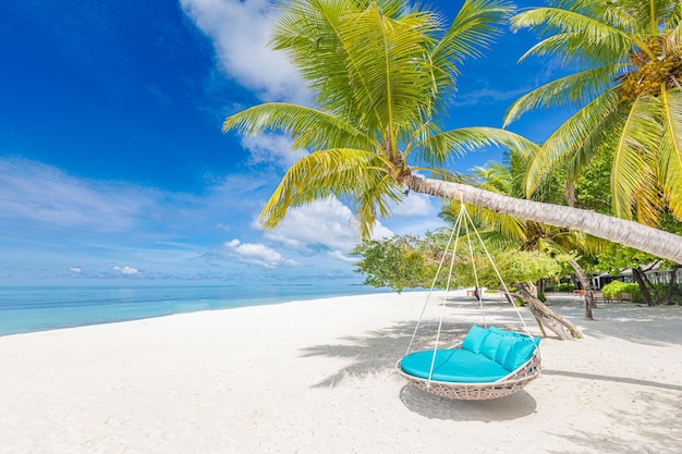 Tropical beach background as summer landscape with beach swing or hammock on palm. Freedom island