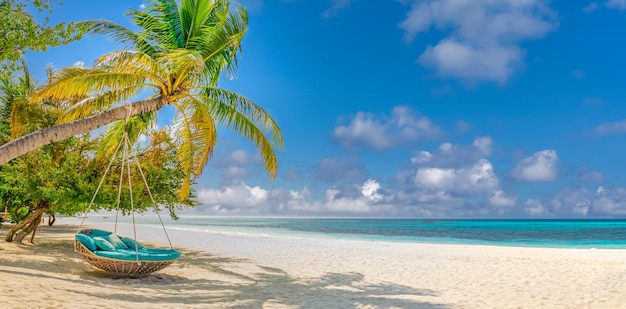 Tropical beach background as summer landscape with beach swing or hammock and white sand sea sky