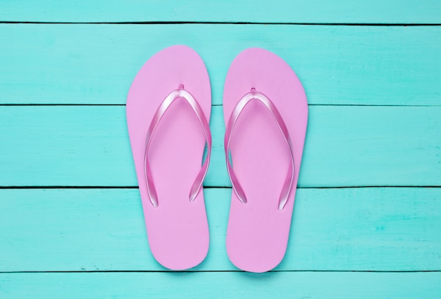 Tropical beach lifestyle. Flip flops on blue wooden background. Summer background. Top view