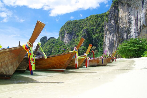 Tropical beach longtail boats Andaman Sea Thailand