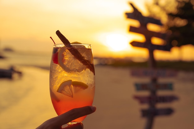 Tropical cocktail with sunset over the sea on the background,summer vacation trip