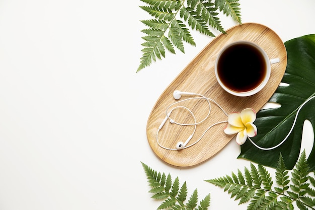 Tropical eco desk table with headphones and coffee