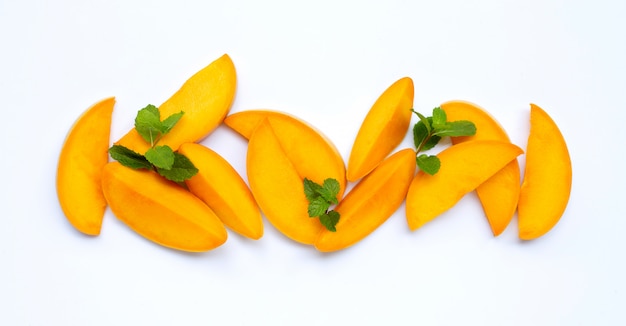 Tropical fruit, Mango slices with mint leaves  on white .