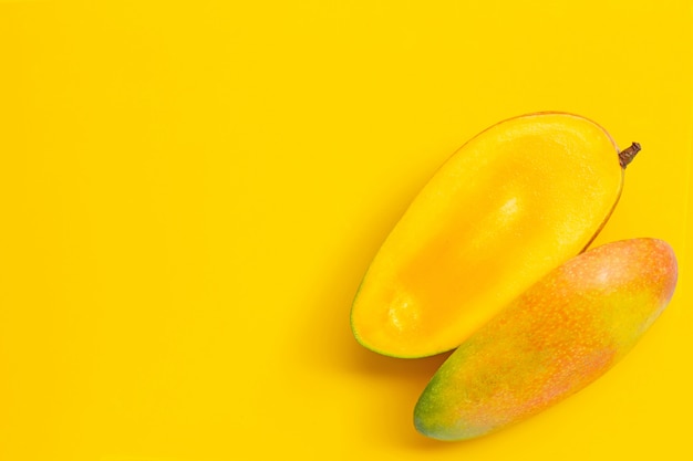 Tropical fruit, Mango on yellow background. Copy space