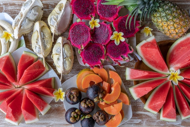 Tropical fruits assortment closeup top view Many colorful ripe fruits background Durian papaya watermelon banana mangosteen pineapple and pitahaya or dragon fruit in island Bali Indonesia