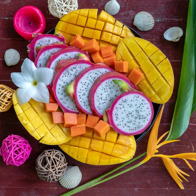 Tropical fruits assortment on a plate, close up 