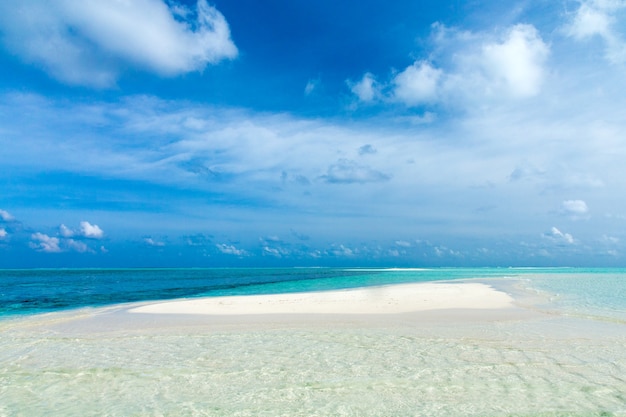 Tropical Maldives island with white sandy beach and sea