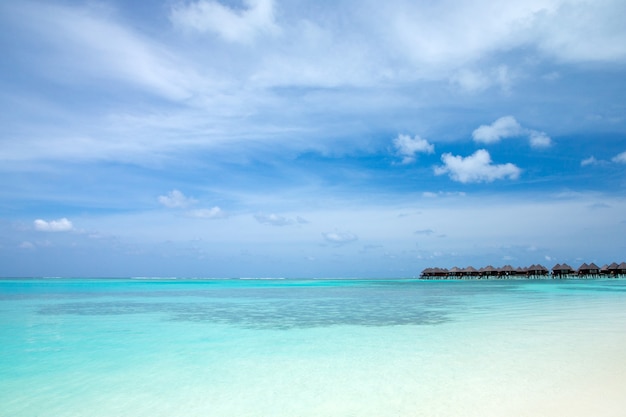 Tropical Maldives island with white sandy beach and sea