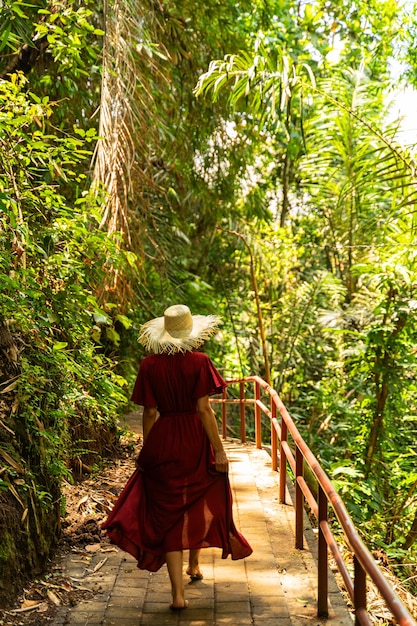 Tropical nature. Relaxed female person enjoying green plants while spending her vacation on the island