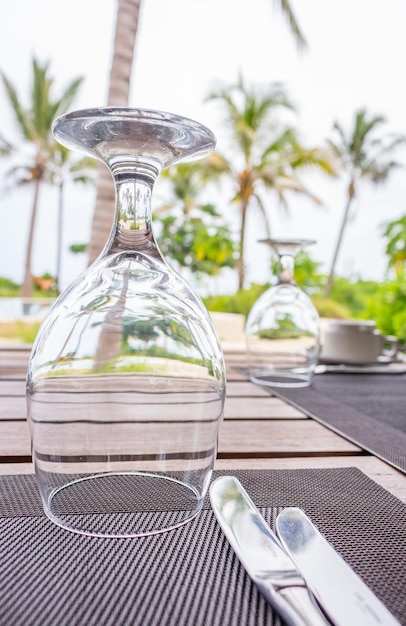 Tropical outdoor restaurant Table set on cafe table Cafe near resort pool with palm trees