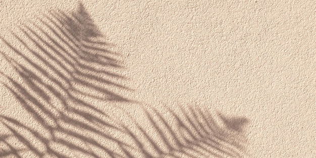 Tropical palm branch with shadow on a beige concrete wall natural texture Abstract background Copy space Summer grunge wallpaper with minimal concept Mockup overlay effect and natural lightning