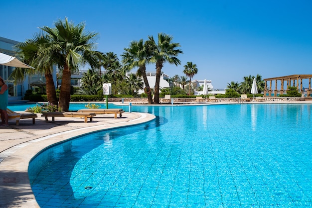 Tropical resort with many palms and pool