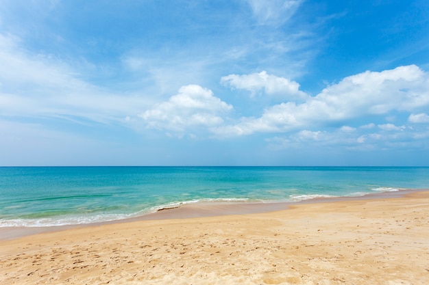 Tropical sandy beach and blue ocean, blue sky