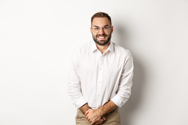 Troubled man having bladder problem, need toilet, standing over white background. Copy space