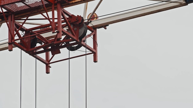 Photo truck construction tower crane traveling on the boom closeup