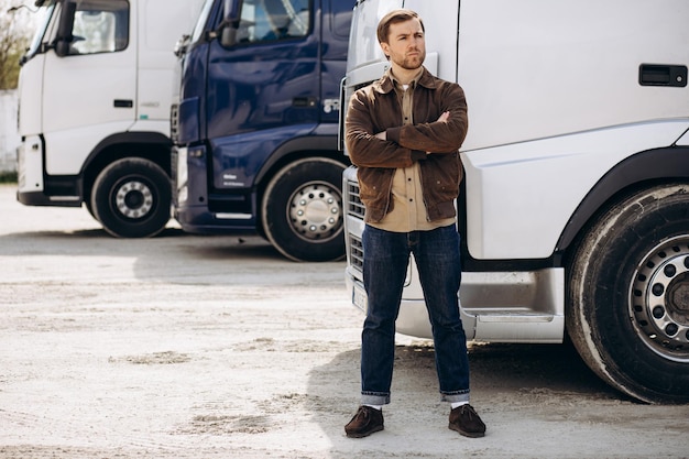 Truck driver stopped on the road reparing his lorry