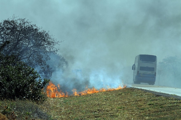 A truck is on fire on a road