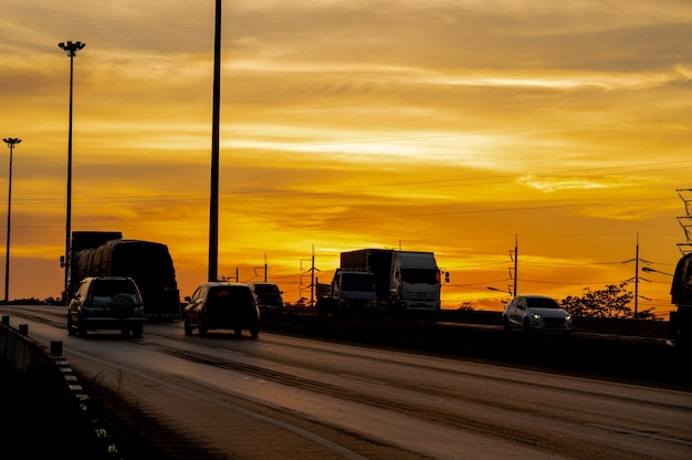 Truck with Cargo driving on road transportation highway at sunset in summer