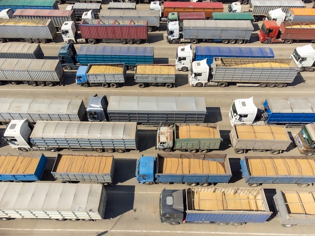 Trucks loaded with grain are waiting top view Trucks in the port terminal are waiting to be unloaded