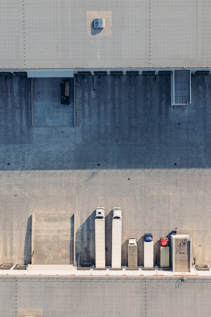 Trucks with trailers wait for the loading of goods for transportation in the loading warehouse aeria...