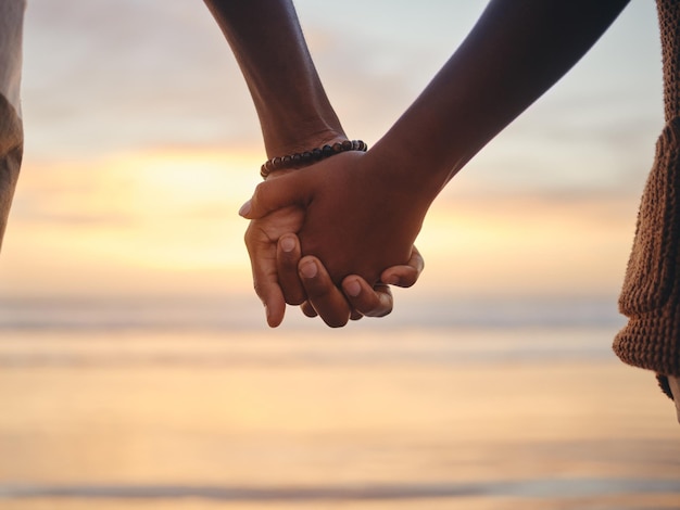 Trust love and holding hands with couple by the beach together for support happy and relax on Miami summer vacation Sunset vision and nature with black man and woman on peace holiday