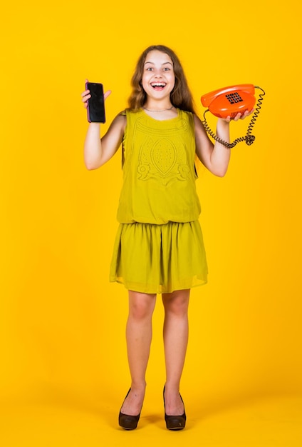 Try both back to basics talking by retro telephone Business communication concept childhood Small kid having fun Portrait of business girl in office success creativity and innovation