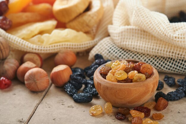 Tu Bishvat celebration concept Mix of dry fruits and almonds hazelnuts walnuts apricots prunes cherries raisins dates apples figs on old tile table background Jewish holiday new year of trees