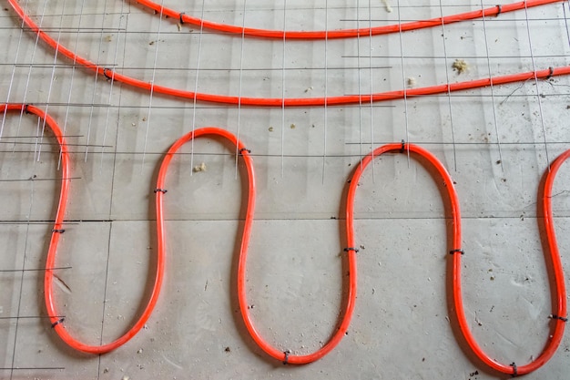 Tubes of the underfloor heating system on a styrofoam insulation