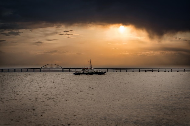 A tugboat at sea before a thunderstorm.