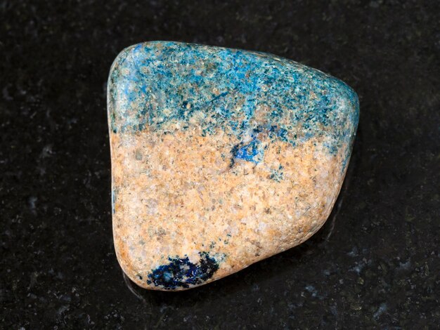 Tumbled azurite stone on dark background