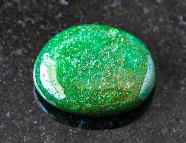 Tumbled green Aventurine gem stone on black