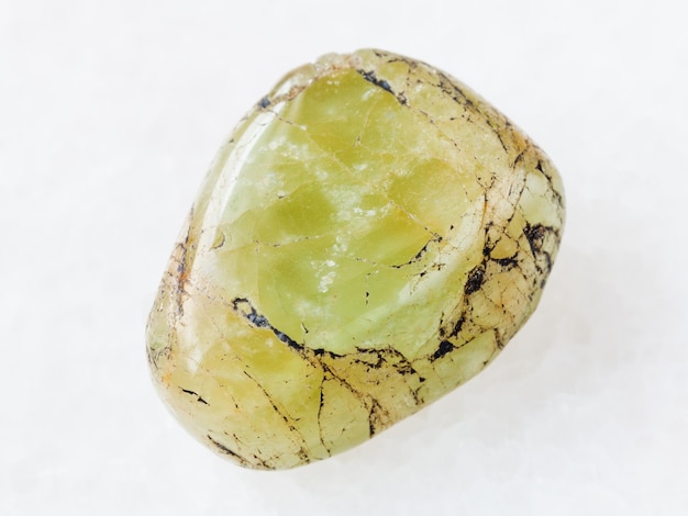 Tumbled green beryl gem stone on white