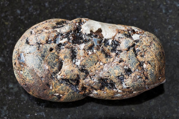 Tumbled sphalerite stone with Galena on dark