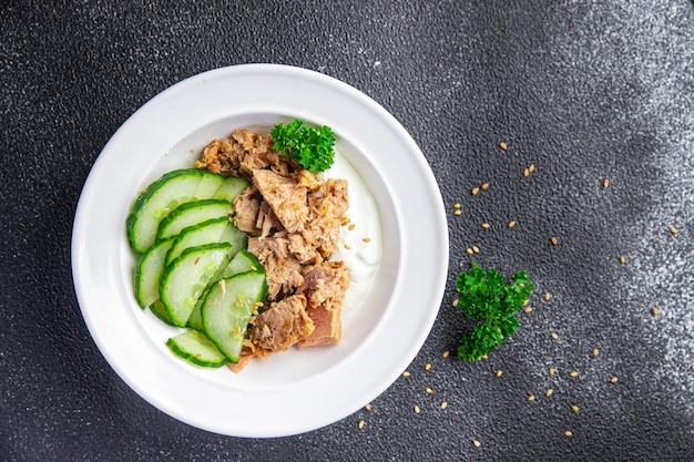 tuna salad, cucumber and yogurt or sour cream meal food snack on the table copy space food