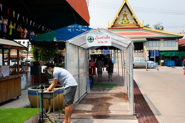 Tunel for cleaning and disinfecting surfaces anti virus bacteria for thai people travelers use service before travel visit Wat Lam Phaya Floating Market on April 9 2022 in Nakhon Pathom Thailand