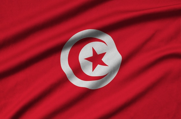 Tunisia flag  is depicted on a cloth fabric with many folds