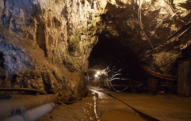 Tunnel with railway and electricity mine cables of underground mining production and technology