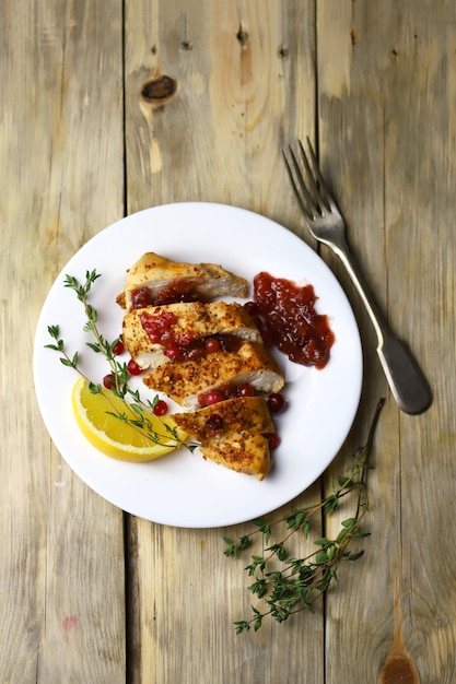 Turkey fillet with cranberry sauce presented on a plate.