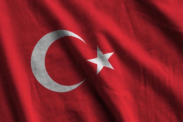 Turkey flag with big folds waving close up under the studio light indoors the official symbols and c