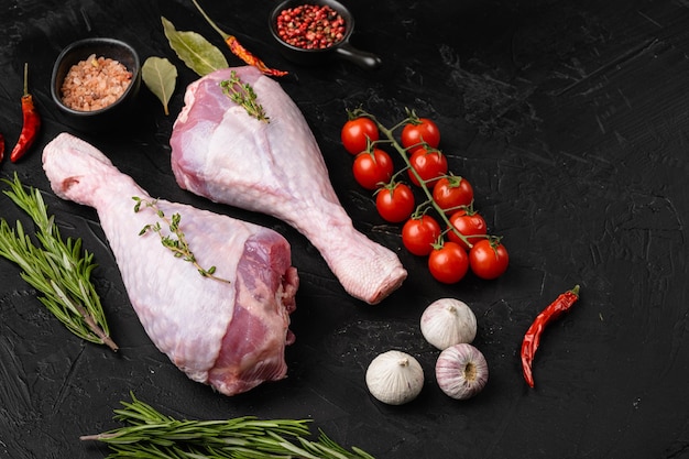 Turkey meat raw thigh with spices on black dark stone table background top view flat lay with copy space for text