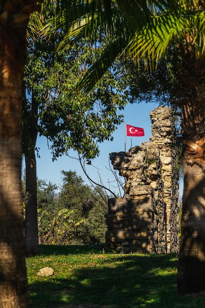 Turkish antique ruins with national Turkish flag flutters