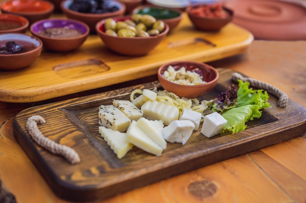 Turkish breakfast cheese pastries vegetables greens olives cheeses fried eggs spices jams honey tea