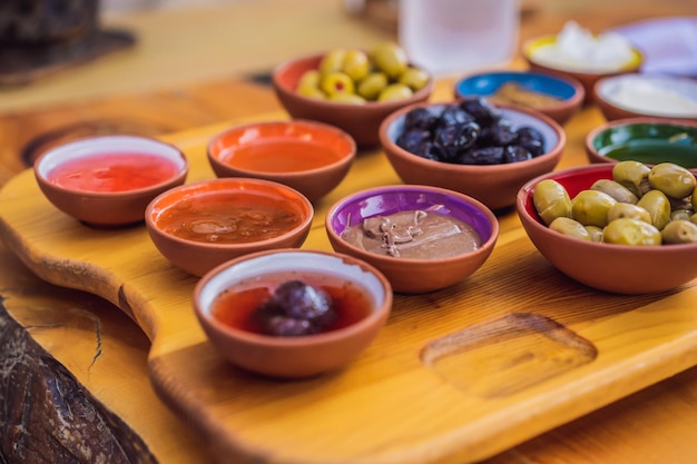 Turkish breakfast table pastries vegetables greens olives cheeses fried eggs spices jams honey tea