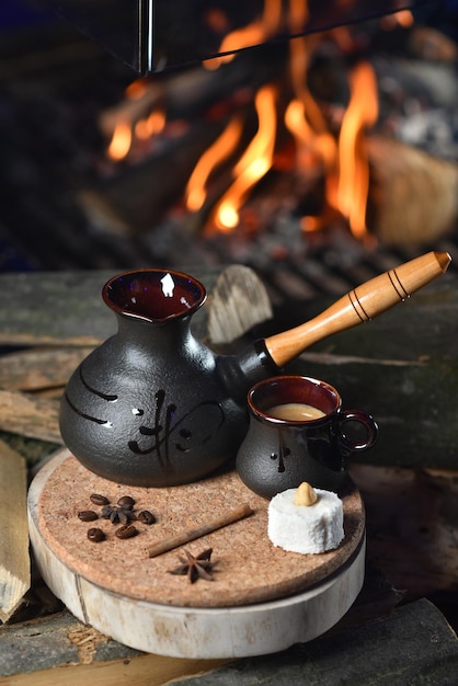 Turkish coffee in black turk on fire background